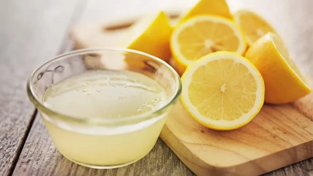 Fresh lemons and lemon juice bowl